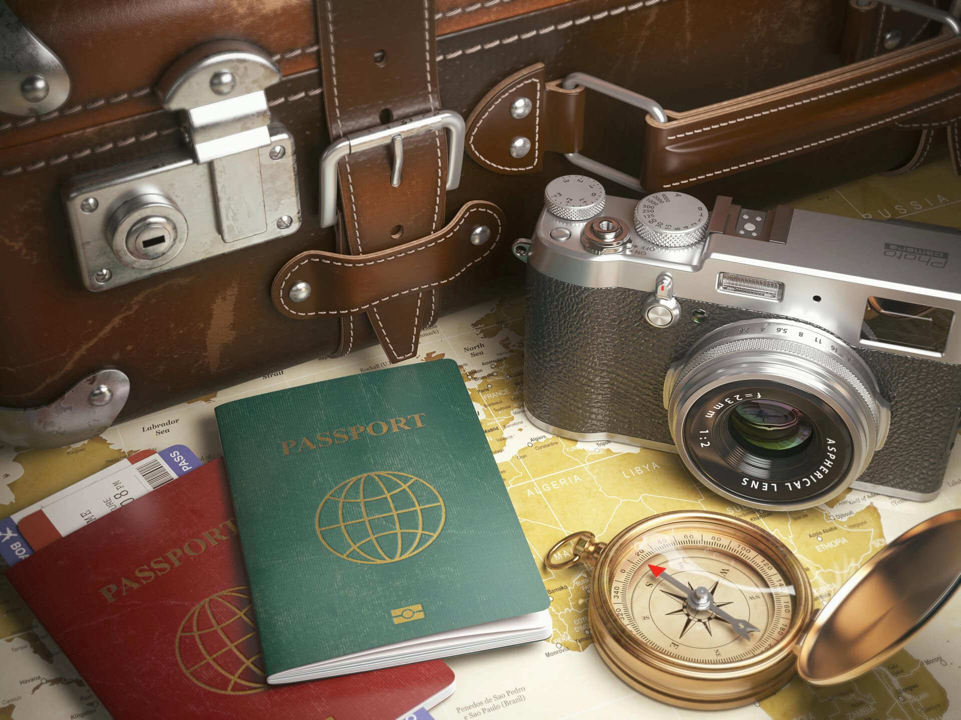 Old suitcase, passports, camara and pocket watch