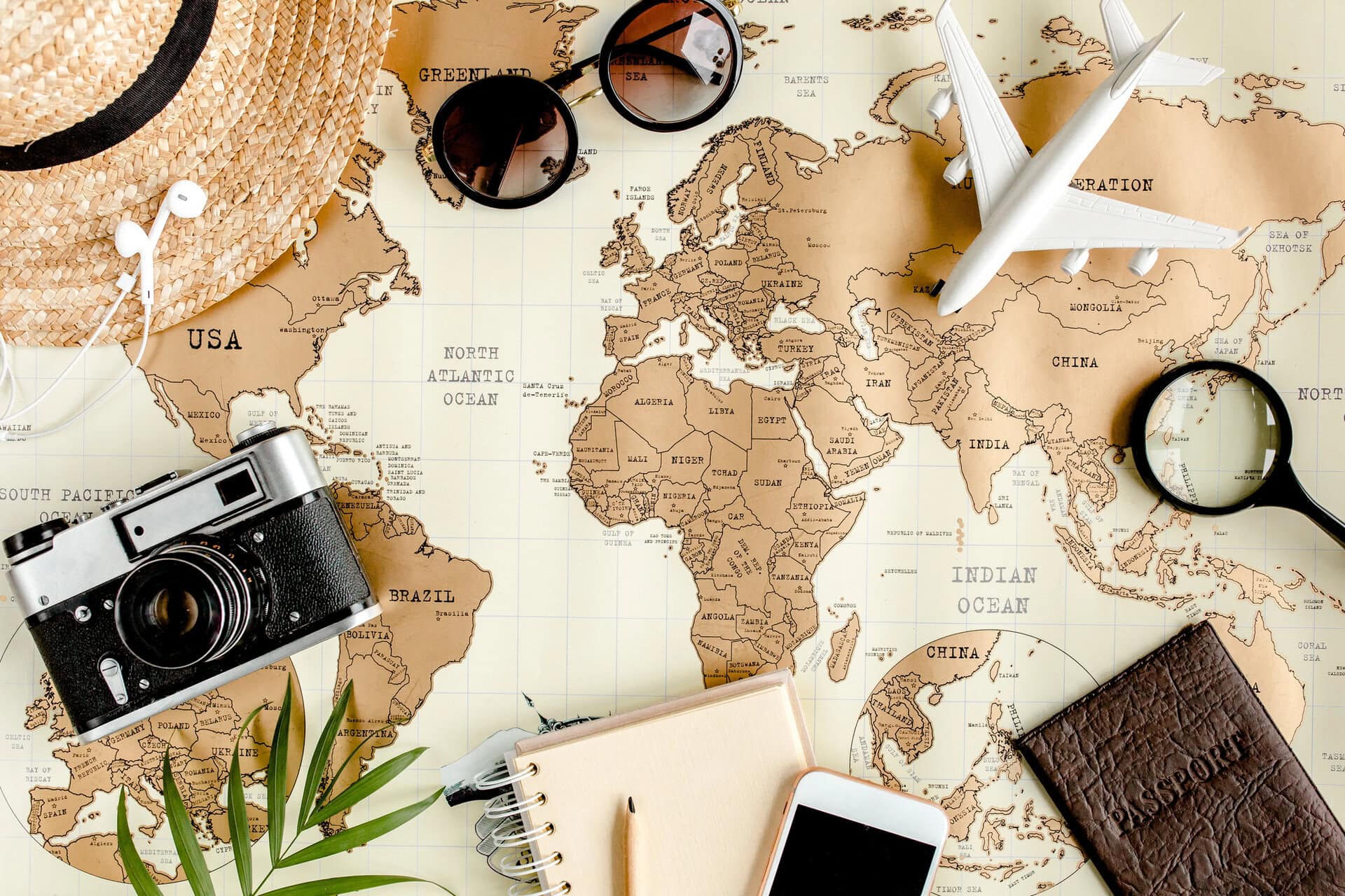 Planning vacation, travel plan, trip vacation using world map along with other travel accessories.